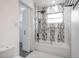 Modern bathroom featuring a black shower head and mosaic tile design above the white bathtub and marble floors at 1231 Beacon Dr, Port Charlotte, FL 33952