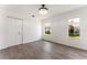 Bedroom with hardwood floors, closet, and two windows offering natural light and backyard views at 1231 Beacon Dr, Port Charlotte, FL 33952