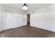 Bright bedroom features hardwood floors, double-door closet, and a view into the adjacent room at 1231 Beacon Dr, Port Charlotte, FL 33952