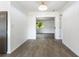 Bright hallway featuring hardwood floors and an open entryway to another room at 1231 Beacon Dr, Port Charlotte, FL 33952