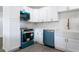 Bright kitchen showcases white cabinetry, stainless appliances, and a mosaic tile backsplash at 1231 Beacon Dr, Port Charlotte, FL 33952