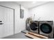 A clean laundry room is equipped with gray Samsung washer and dryer, and ample room for chores at 1231 Beacon Dr, Port Charlotte, FL 33952