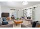 This living room features sliding barn doors, a light gray sofa, and a bright overhead light fixture at 1231 Beacon Dr, Port Charlotte, FL 33952