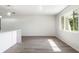 Bright, empty living room featuring neutral walls, new flooring, and lots of natural light from the window at 1231 Beacon Dr, Port Charlotte, FL 33952