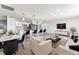 Staged open-concept living room and kitchen area with modern decor, sleek furniture, and stylish accents at 1231 Beacon Dr, Port Charlotte, FL 33952