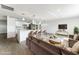 Staged open-concept living room and kitchen area with modern decor, sleek furniture, and stylish accents at 1231 Beacon Dr, Port Charlotte, FL 33952