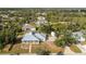 Beautiful home featuring a metal roof, screened-in porch, lush landscaping, and a private driveway at 13204 Kakapo Ave, Port Charlotte, FL 33981
