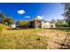 Expansive backyard featuring a screened patio, lawn and perimeter fence at 13204 Kakapo Ave, Port Charlotte, FL 33981