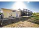 Wide-angle view of the backyard that features a screened patio and spacious grassy area at 13204 Kakapo Ave, Port Charlotte, FL 33981