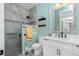 Bright bathroom with a glass door shower, double shelves, and modern vanity at 13204 Kakapo Ave, Port Charlotte, FL 33981