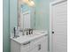 Well-lit powder room featuring quartz countertop and a framed mirror at 13204 Kakapo Ave, Port Charlotte, FL 33981