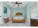 Bedroom with wooden bed frame, ceiling fan, and a comfortable window seat at 13204 Kakapo Ave, Port Charlotte, FL 33981