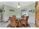 Charming dining area with a glass table, wooden chairs, and a view of the pool area through the window at 13204 Kakapo Ave, Port Charlotte, FL 33981