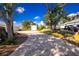Paver driveway leads to a house with a separate garage and ample parking space at 13204 Kakapo Ave, Port Charlotte, FL 33981