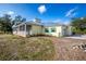 Exterior view showcasing the home's well-maintained lawn and adjacent garage at 13204 Kakapo Ave, Port Charlotte, FL 33981