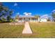 Inviting home exterior features a paved walkway and lush lawn at 13204 Kakapo Ave, Port Charlotte, FL 33981