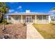 Well-maintained home facade with inviting front porch and meticulously kept landscaping at 13204 Kakapo Ave, Port Charlotte, FL 33981