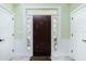 Beautiful dark wooden front door with decorative glass panels, flanked by white trim and sidelights at 13204 Kakapo Ave, Port Charlotte, FL 33981