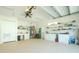 Spacious garage with utility sink, cabinets, and ladder at 13204 Kakapo Ave, Port Charlotte, FL 33981