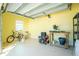Spacious garage with yellow walls, storage shelves, and room for bikes and equipment at 13204 Kakapo Ave, Port Charlotte, FL 33981
