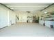 Spacious garage with utility sink, cabinets, ladder, and overhead lighting at 13204 Kakapo Ave, Port Charlotte, FL 33981