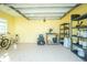 Spacious garage with yellow walls, storage shelves, and room for bikes and equipment at 13204 Kakapo Ave, Port Charlotte, FL 33981
