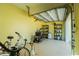 Spacious garage with yellow walls and open door, showcasing storage shelves at 13204 Kakapo Ave, Port Charlotte, FL 33981