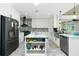 Bright kitchen with stainless steel appliances, an island, and sleek cabinetry at 13204 Kakapo Ave, Port Charlotte, FL 33981