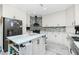 Sleek white kitchen featuring stainless steel appliances and an island at 13204 Kakapo Ave, Port Charlotte, FL 33981