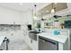 Bright kitchen features stainless steel appliances, white cabinetry, and butcher block countertops at 13204 Kakapo Ave, Port Charlotte, FL 33981