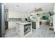 Open kitchen with island, stainless steel appliances, and view to the living room at 13204 Kakapo Ave, Port Charlotte, FL 33981