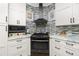 Galley-style kitchen featuring stainless steel appliances and tile backsplash at 13204 Kakapo Ave, Port Charlotte, FL 33981