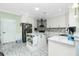 Well-lit kitchen with stainless steel appliances, an island, and sleek cabinetry at 13204 Kakapo Ave, Port Charlotte, FL 33981