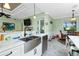 Well-lit kitchen with stainless steel sink, marble countertops, and ample cabinet space at 13204 Kakapo Ave, Port Charlotte, FL 33981