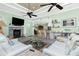 Cozy living room with a brick fireplace, bar seating, and stylish decor; perfect for entertaining at 13204 Kakapo Ave, Port Charlotte, FL 33981