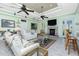 Comfortable living room with a fireplace, bar seating, and a light, airy atmosphere at 13204 Kakapo Ave, Port Charlotte, FL 33981