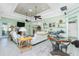 Open-concept living room featuring a fireplace, comfortable seating, and an elegant coffered ceiling at 13204 Kakapo Ave, Port Charlotte, FL 33981