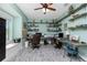 Spacious office with dual desks, shelving, window seat and ceiling fan at 13204 Kakapo Ave, Port Charlotte, FL 33981