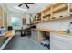 Bright office space featuring built-in shelves, spacious countertops, and a ceiling fan for optimal comfort at 13204 Kakapo Ave, Port Charlotte, FL 33981