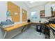 Well-lit office with custom desk, bulletin boards, and a convenient shredder for productivity and organization at 13204 Kakapo Ave, Port Charlotte, FL 33981