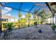 Enclosed patio area featuring brick pavers, well-maintained landscaping, and a serene atmosphere at 13204 Kakapo Ave, Port Charlotte, FL 33981