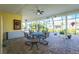 Spacious screened patio featuring brick pavers, comfortable seating, and picturesque outdoor views at 13204 Kakapo Ave, Port Charlotte, FL 33981