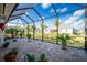 Enclosed patio featuring brick pavers, well-maintained landscaping, and a serene atmosphere at 13204 Kakapo Ave, Port Charlotte, FL 33981