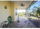A screened-in patio with a brick floor and ceiling fan offers an outdoor relaxation space at 13204 Kakapo Ave, Port Charlotte, FL 33981