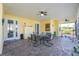 Comfortable patio featuring pavers, outdoor seating, dart board, and access to the well-manicured backyard at 13204 Kakapo Ave, Port Charlotte, FL 33981