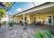 Spacious outdoor patio with pavers, comfortable seating, tropical foliage and access to lush backyard at 13204 Kakapo Ave, Port Charlotte, FL 33981