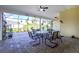 Enclosed patio showcasing brick pavers, comfortable seating, and lush greenery, perfect for relaxation at 13204 Kakapo Ave, Port Charlotte, FL 33981