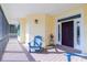 Cozy front porch with blue Adirondack chair, offering a welcoming entrance at 13204 Kakapo Ave, Port Charlotte, FL 33981