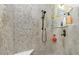 Stunning walk-in shower featuring pebble accent wall and a convenient corner seat at 13204 Kakapo Ave, Port Charlotte, FL 33981