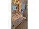 Well-lit bathroom featuring a single sink vanity and shower with glass doors at 13366 Ballon Ave, Port Charlotte, FL 33981